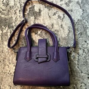 Purple handbag with optional crossbody strap.